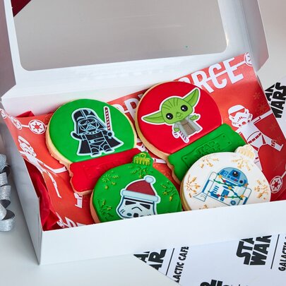 A box of green cookies with Star Wars characters on them. 