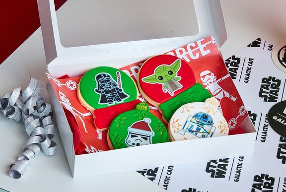 A box of green cookies with Star Wars characters on them. 