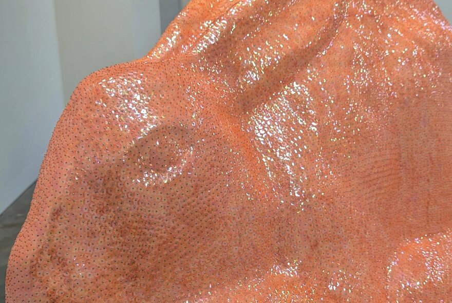 Close up of a salmon coloured resin rabbit sculpture.
