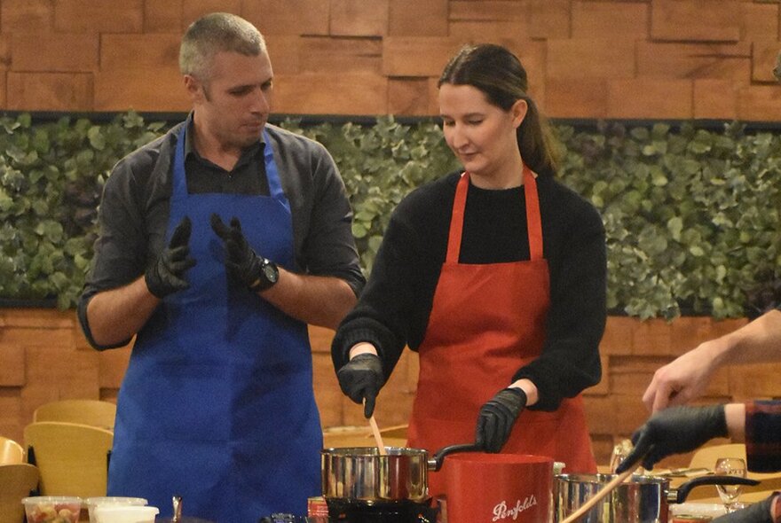 Two people at a cooking workstation during a workshop.