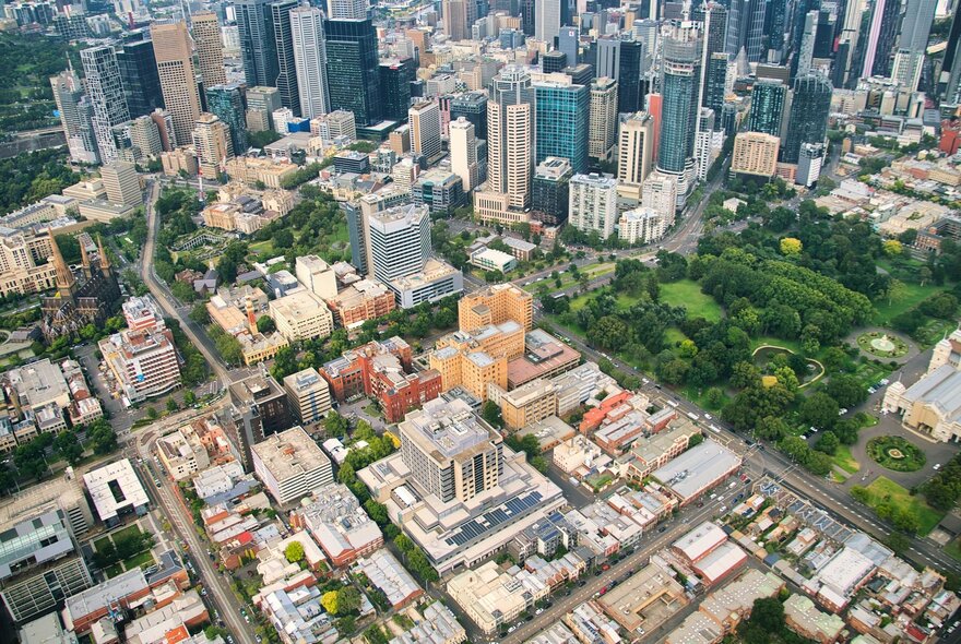 An aerial image of the city of Melbourne that shows blocks, the street grid, tall buildings, and parklands.