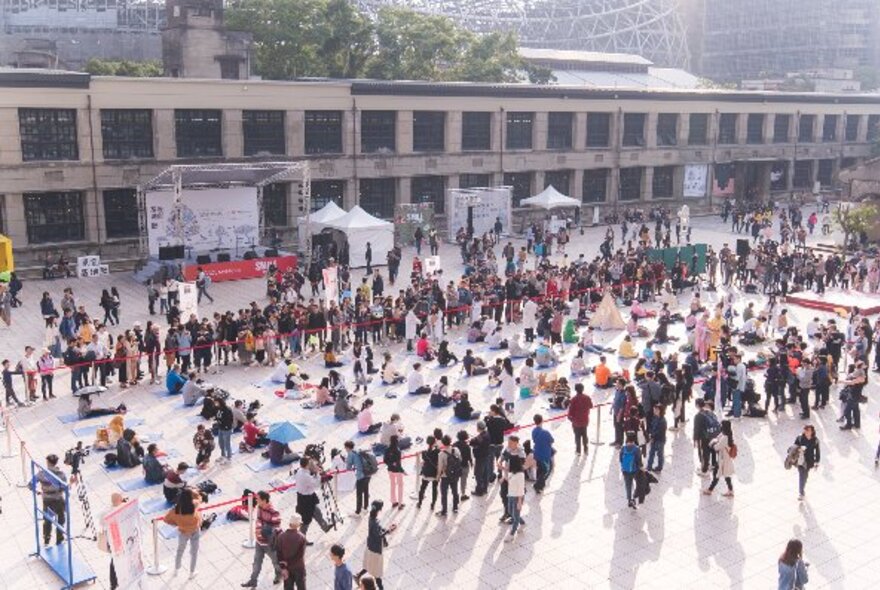 People standing in a large open-air venue.