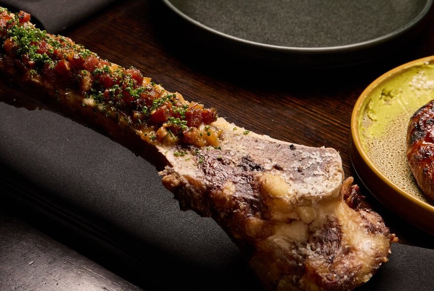 A long cooked bone with marrow that's been garnished. 