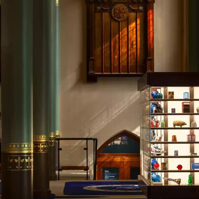 Interior of the ANZ Banking Museum, with artefacts from the bank's history and a display of colourful money boxes, within the restored heritage chamber.