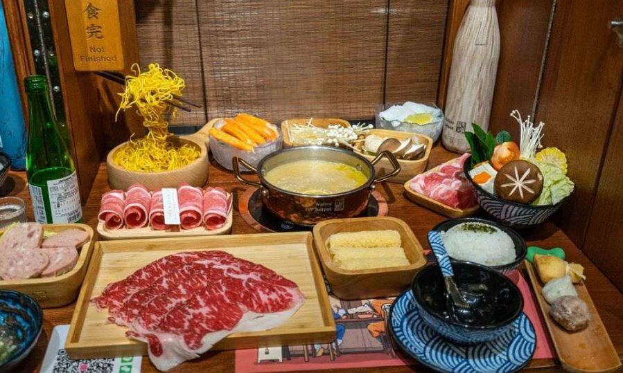 A spread of meet and veggies on a plate in a restaurant