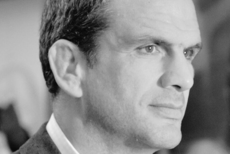 Black and white headshort of rugby great, Martin Johnson, staring out to one side.
