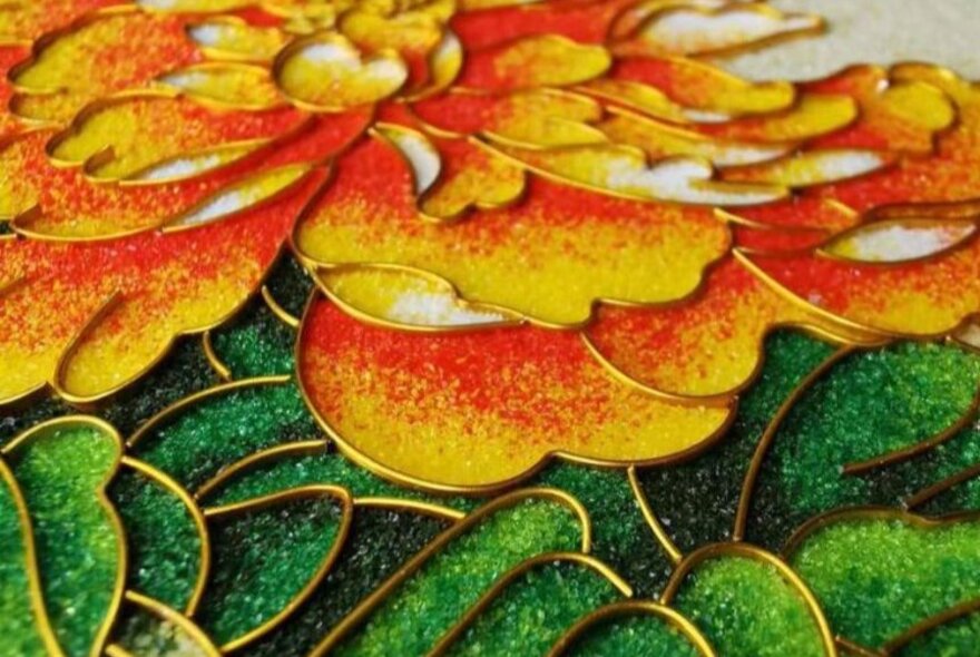 A close up of flower made from enamel craft