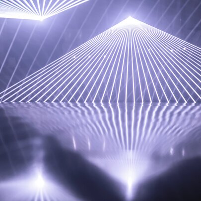 Light beams form geometric planes and vast three-dimensional environments.