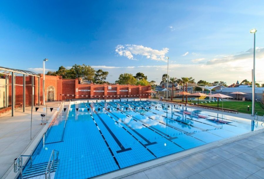 A large 25-metre outdoor pool on a sunny day.
