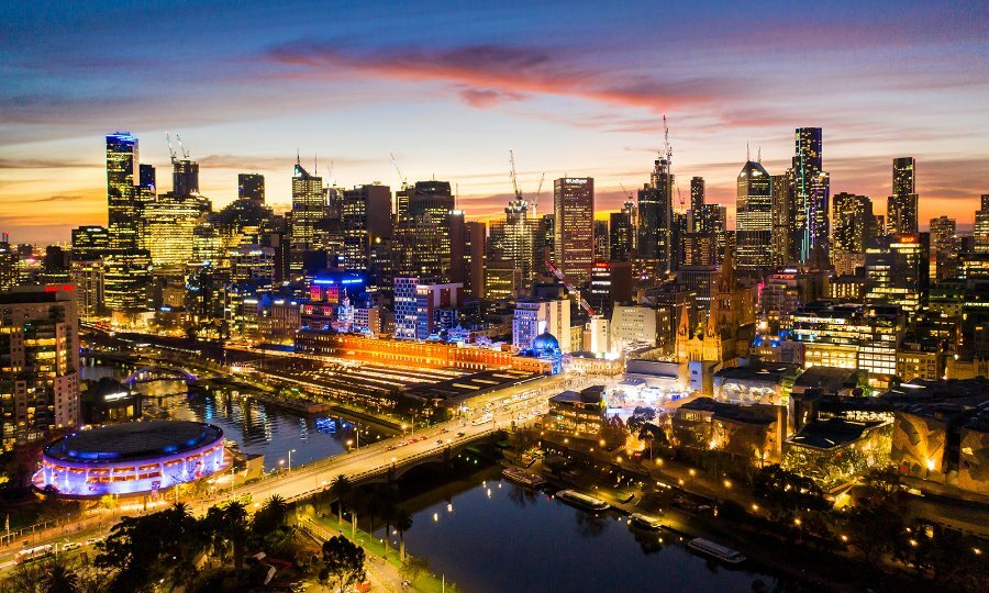 A view over Melbourne by night, with buildings lit up.