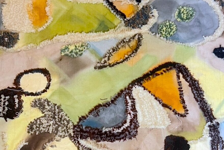 An abstract painting in green blue and orange tones with shapes bordered by black. 