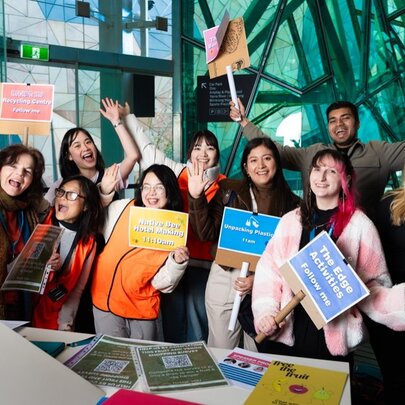 Presenters holding placards in the Atrium at Fed Square.