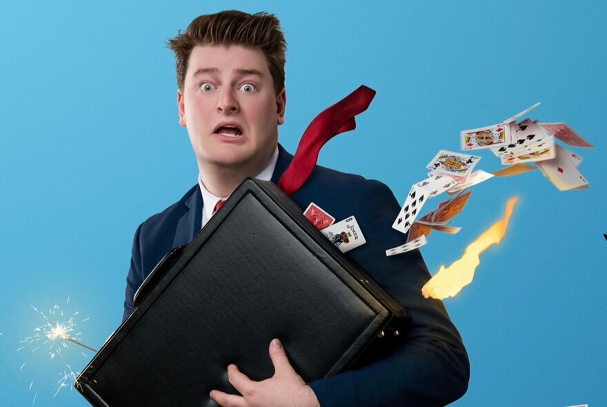 Comic magician holding a briefcase emitting a sparkling wand and playing cards.