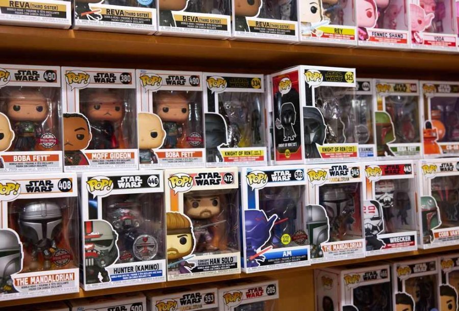 A shelf of Pop! Vinyl figures in a pop culture merchandise shop.