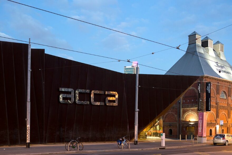 The rusted exterior wall of ACCA, with the Malthouse adjoining.