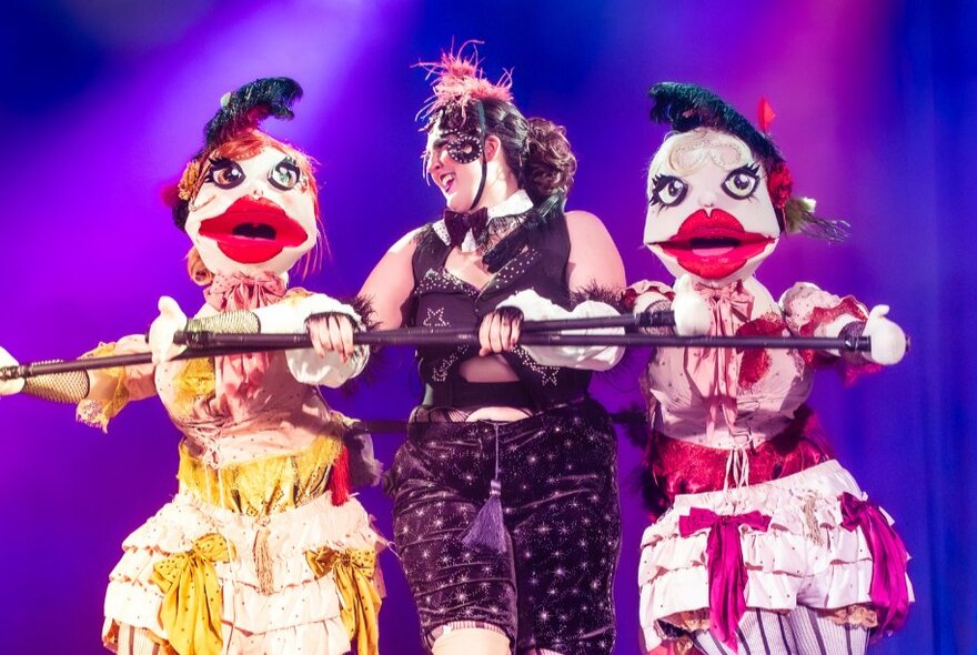 Dancers in bird character costumes performing onstage.