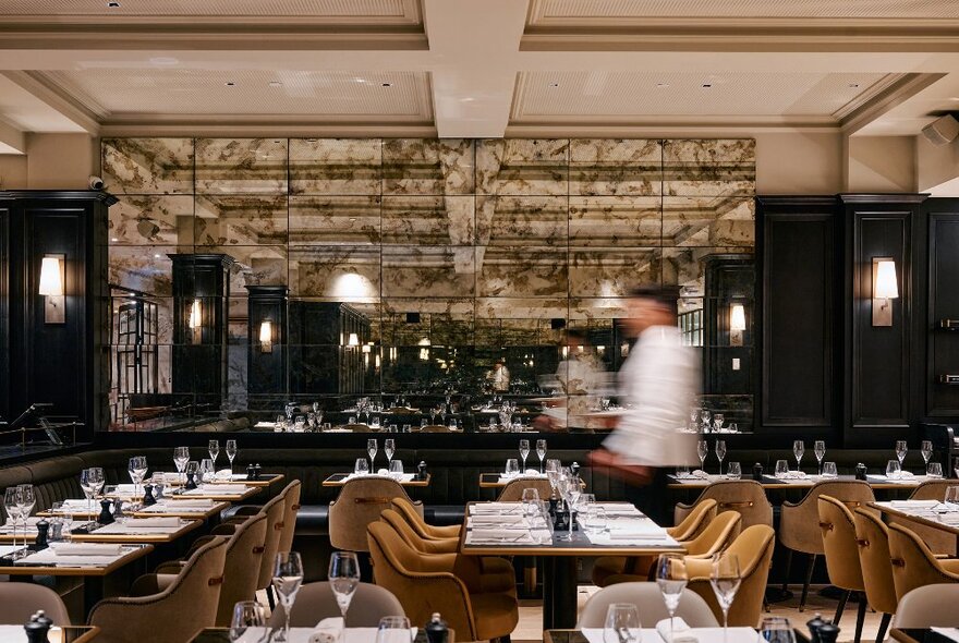 A waiter is walking through a French restaurant. 