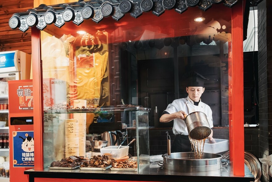 Chef straining noodles at David's Hot Pot Sichuan restaurant.