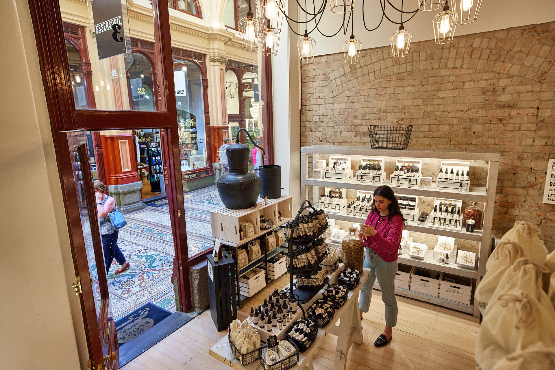 A woman is browsing perfumes in a shop