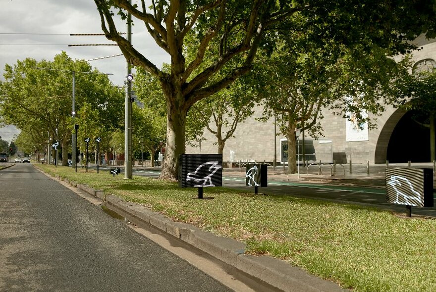 Small screens with birds, along St Kilda Rd, outside National Gallery of Victoria.