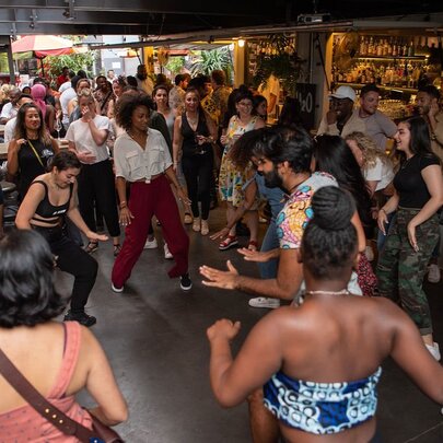 Musicians, dancers and crowd dancing in a small venue.