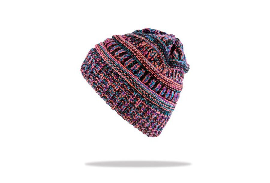 Side shot of a colourful knitted beanie, colours featured are pink, orange, green, blue and black. White background with a shadow below the beanie as though it's hovering.