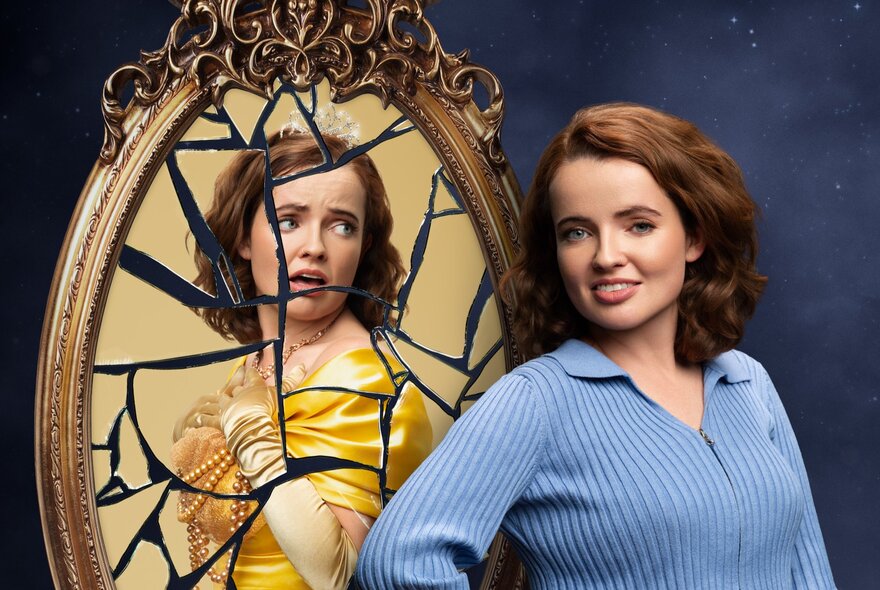 Comedian Roisin McAlinden posing in front of a gilt-framed, shattered oval mirror showing her reflection as a sad fairy tale princess.