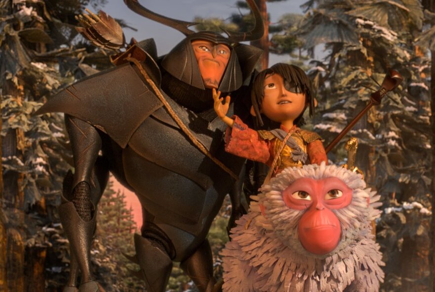A still shot from the animated film Kubo and the Two Strings, featuring three main characters standing together in a leafy forest.