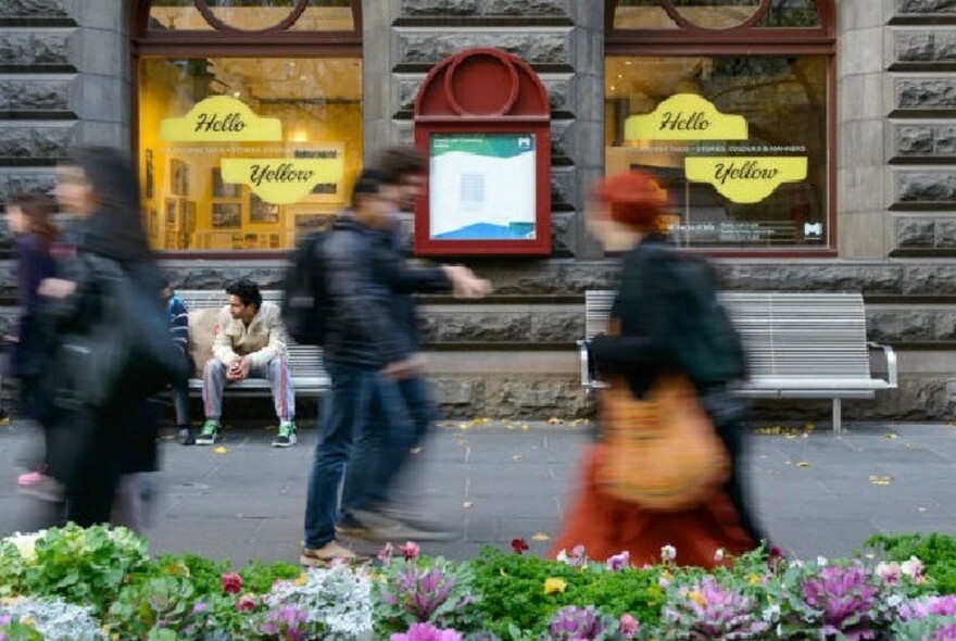 People walking past City Gallery, located within the Melbourne Town Hall building in Swanston Street.