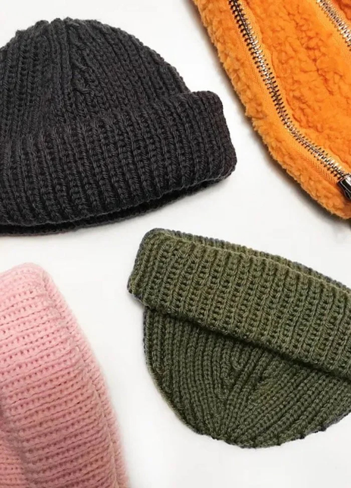 A close-up of multiple different coloured beanies.