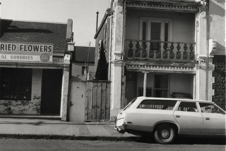 North Melbourne streetscape in the 1980s with terrace house, station wagon and flower shop.