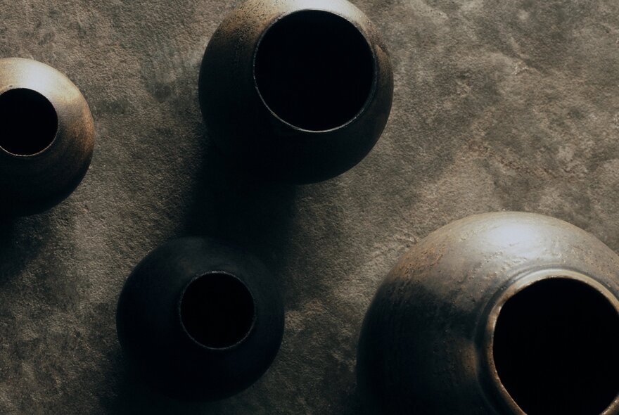 Four earthenware pots seen from above.