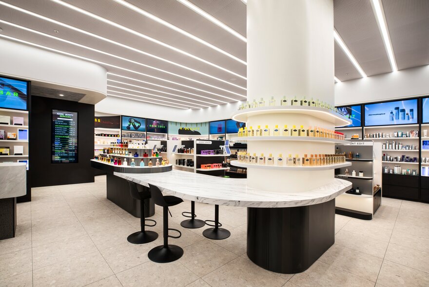 A brightly lit interior of a beauty store with multiple cosmetic display stands and shelves lined with beauty products.
