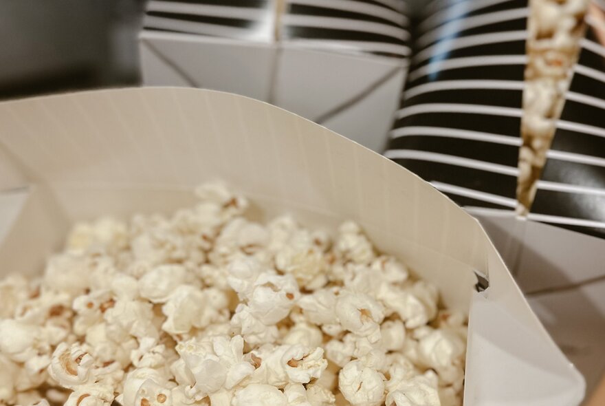 Popcorn in a white cardboard container.