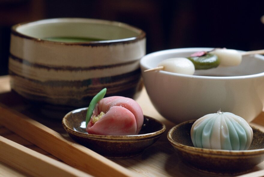 Japanese drinks and sweets on wooden trays.