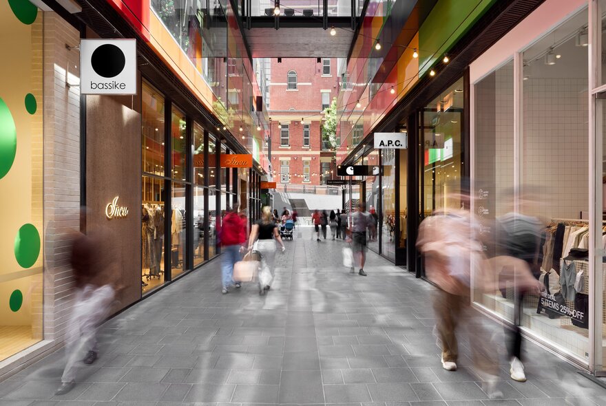 Blurred people walking through one of QV Melbourne's shopping laneways.