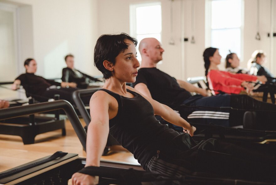 A reformer Pilates class in session. 