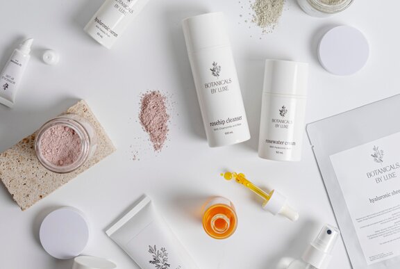 Various skin care products laid out on a white surface.
