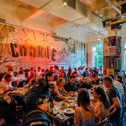 Interior of Cookie restaurant showing many patrons eating at tables.