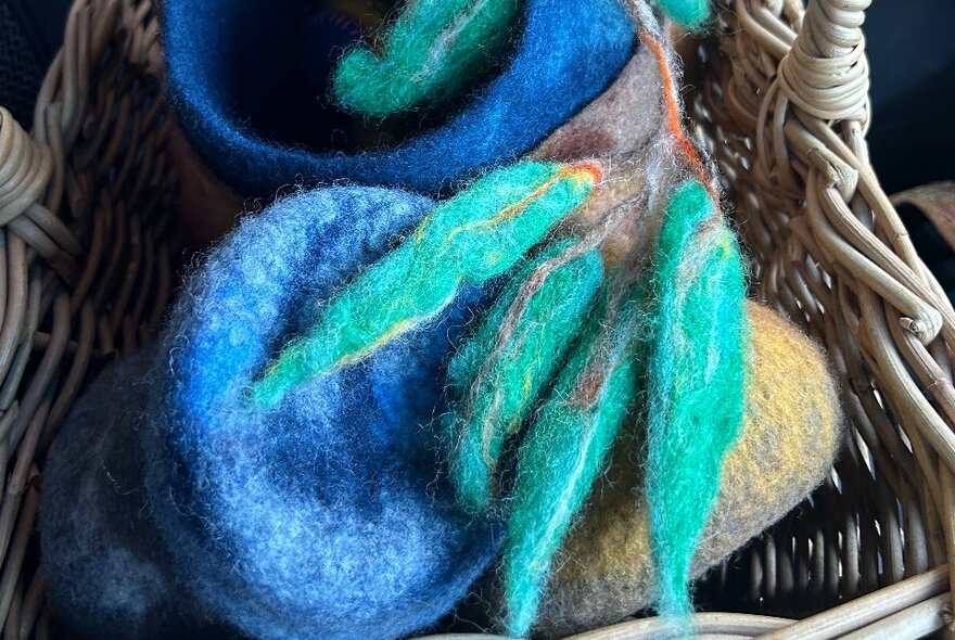 Felted wool artwork of native plants in a basket.