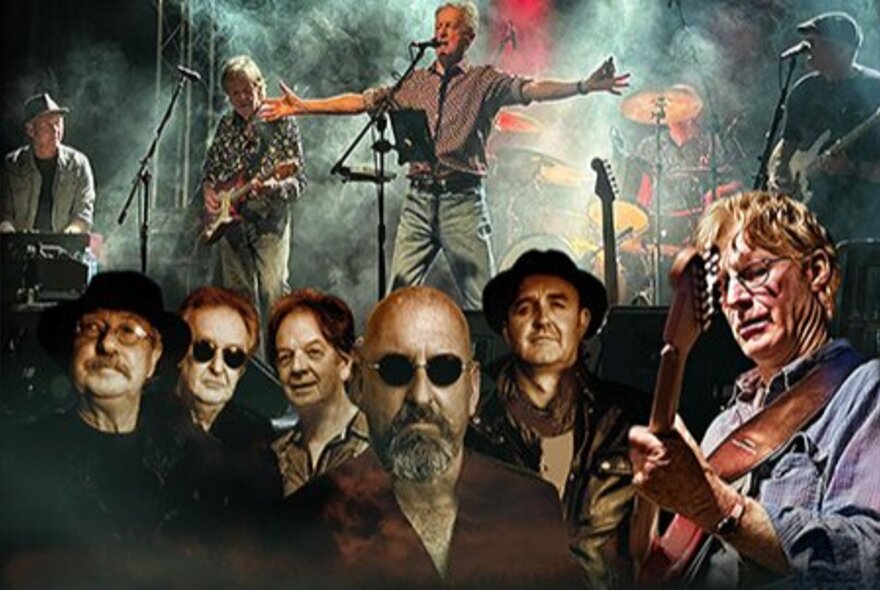 Men wearing sunglasses in front of a band performing on stage.