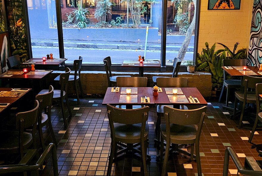 The interior of Matto Napoletano Pizzeria with patterned tile flooring and wooden tables and chairs.