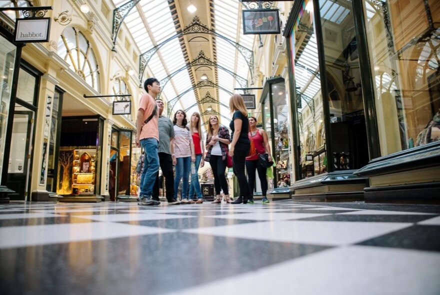 A group of people being guided on a walk through Melbourne's Block Arcade.
