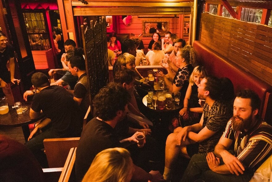 People enjoying drinks at Prudence - a cosy little bar.