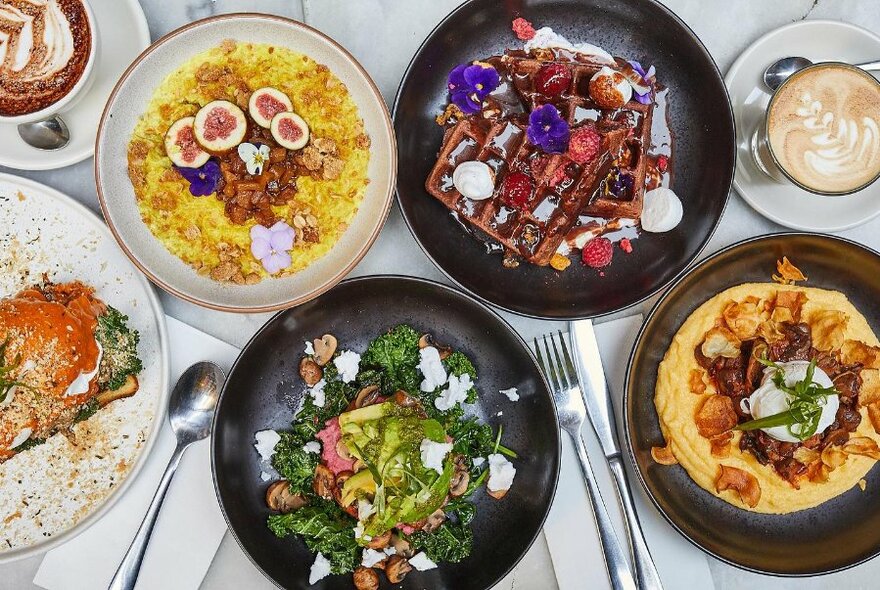 A table full of colourful dishes.