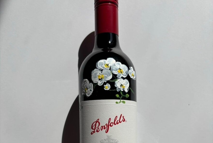Bottle of Penfolds with hand-painted flowers.