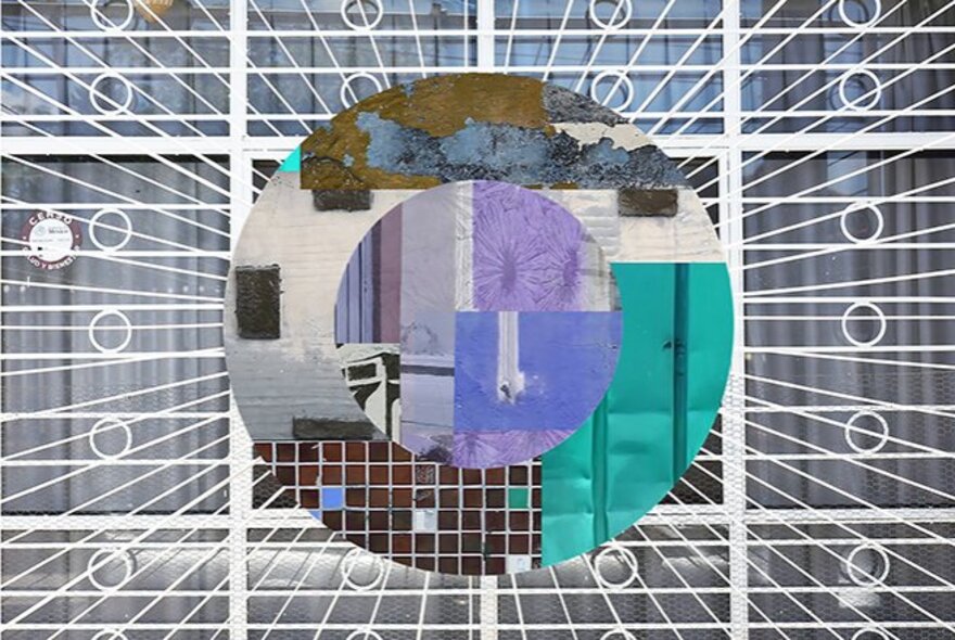 An artwork that superimposes a circular collage of textured, colorful fragments over a black and white image of a white metal security gate.