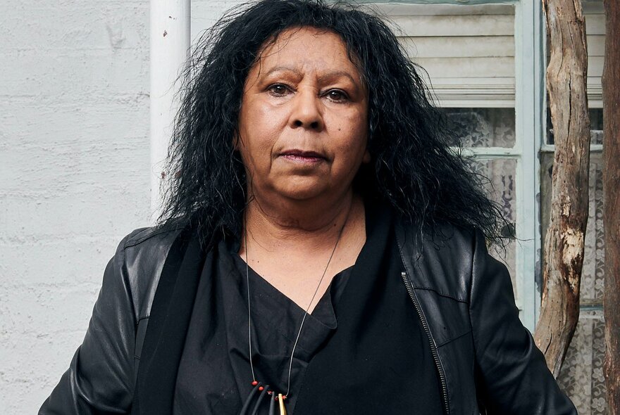 Portrait of Yorta Yorta/Wamba Wamba/Mutti Mutti/Boonwurrung artist, Maree Clarke, wearing a black leather jacket.