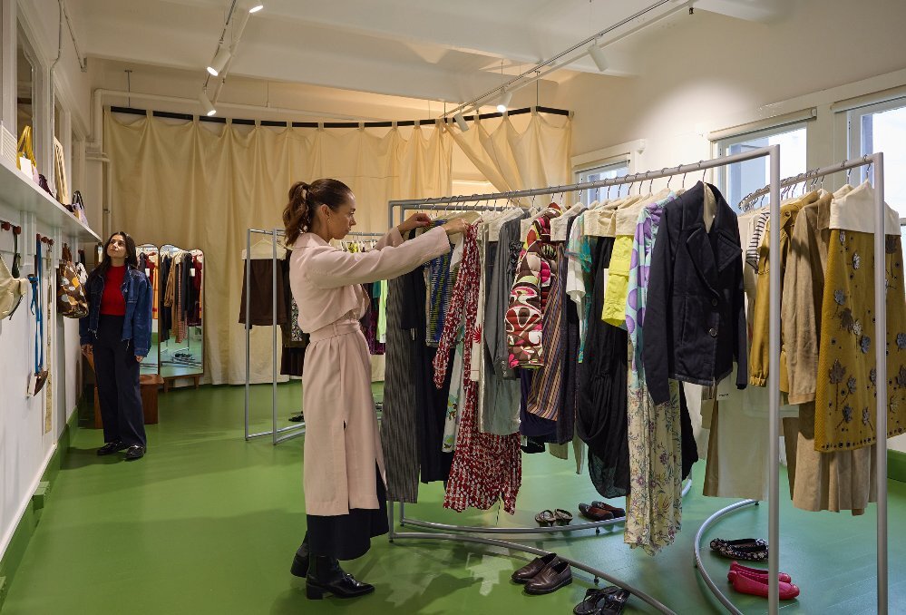 Two women are browsing at a clothing store