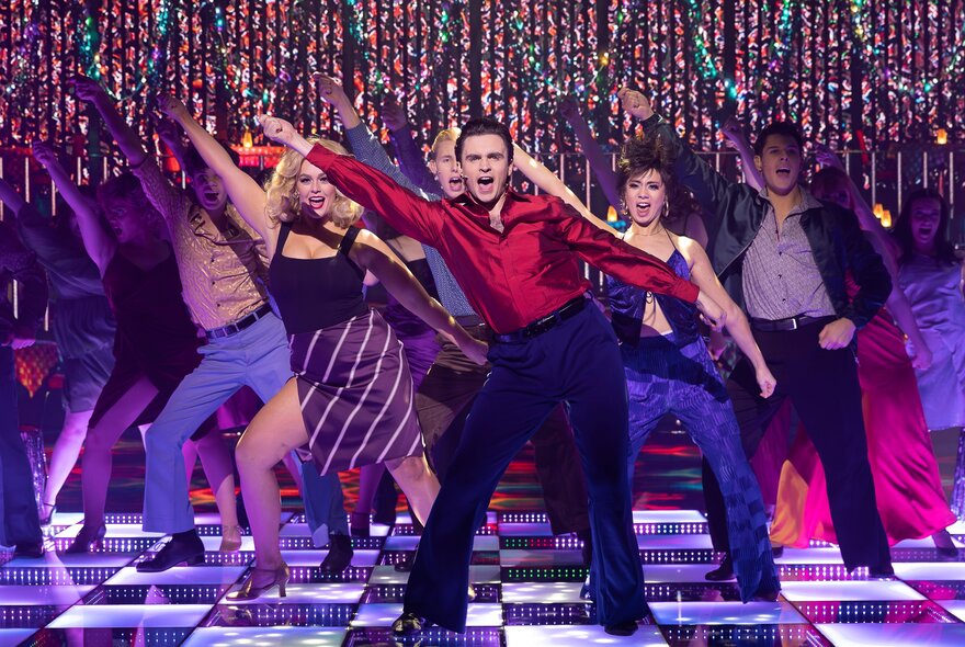 A group performing a dance in unison in Saturday Night Fever. 